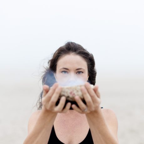 woman holding smocking bowl on the beach